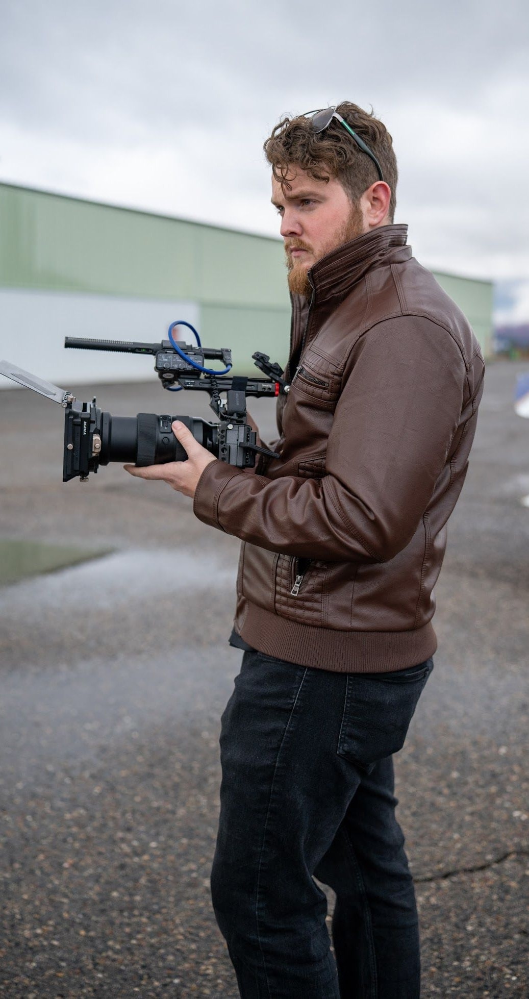 Cyan Lens videographer carrying a cinema camera on location